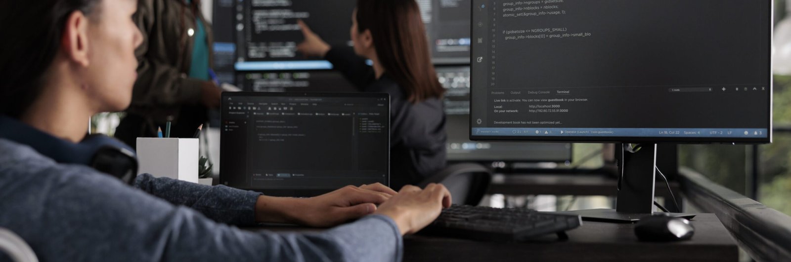 Asian programmer with physical disability typing html code on computer, working with cloud computing terminal window. Web developer in wheelchair writing ai algorithm in it software company.