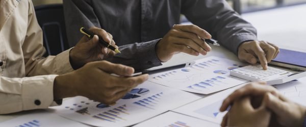 Bookkeeper accountant or financial expert, male economist accounting money with statistics graphs pointing on the accounts for investment results and income Company expenditure